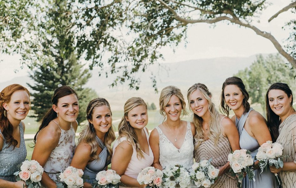 bride with bridesmaids posing on golf course