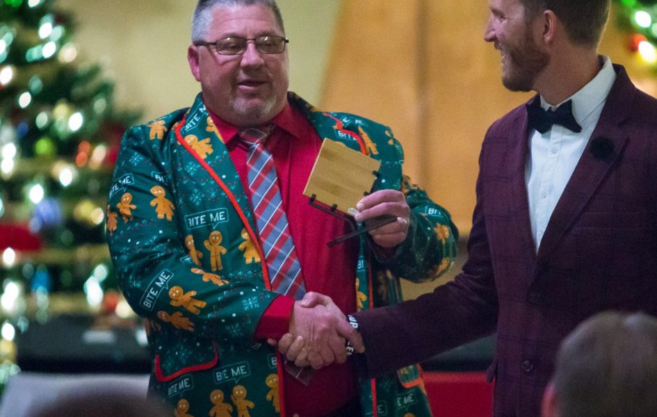 men shaking hands at coldwell christmas party hosted at casper country club
