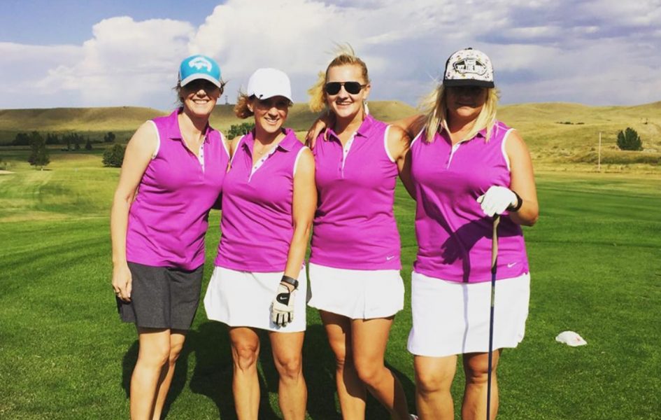 women golfing in matching pink shirts