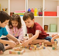 little kids playing with blocks and games