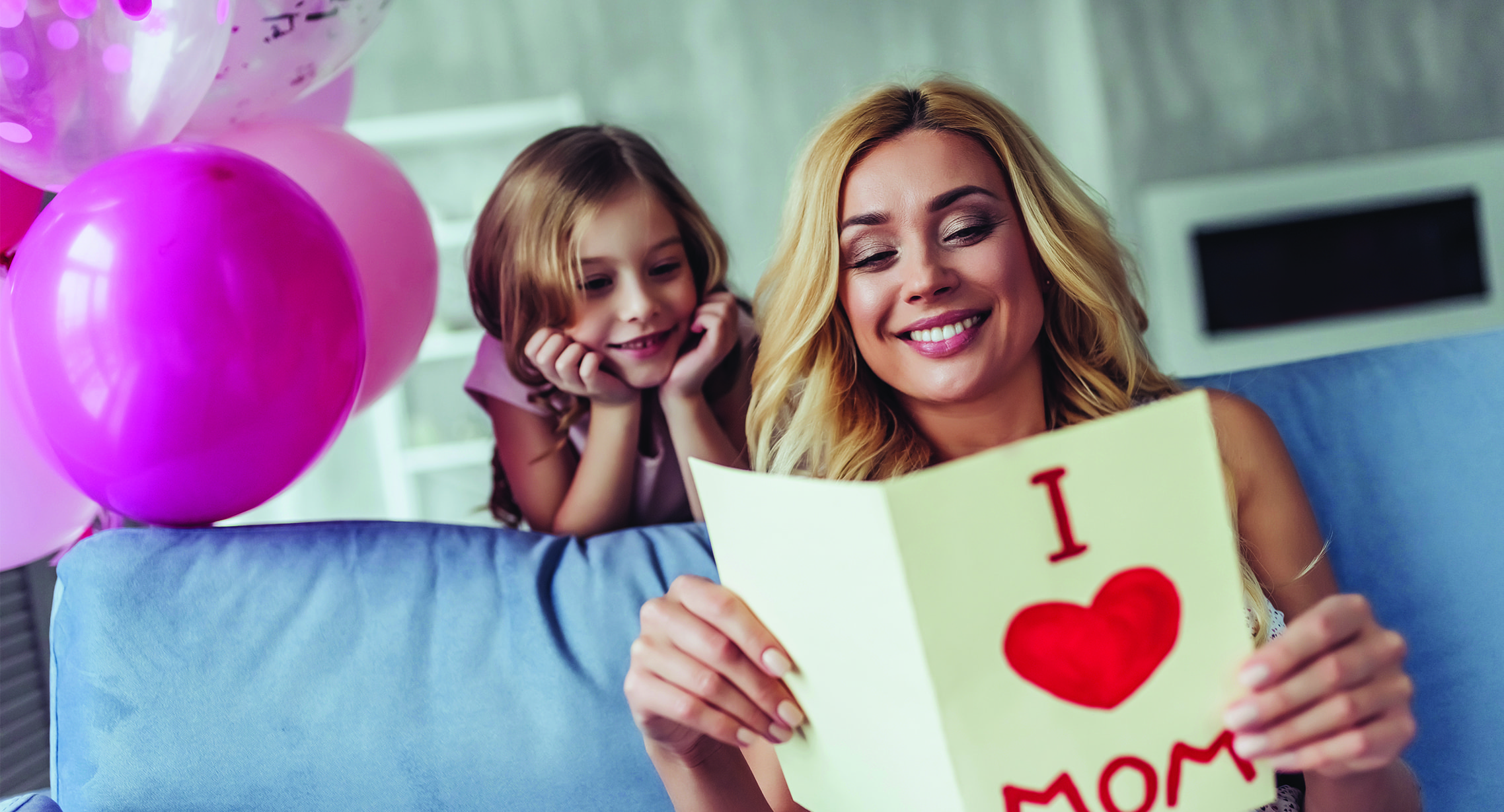 mother reading card from daughter on mother's day